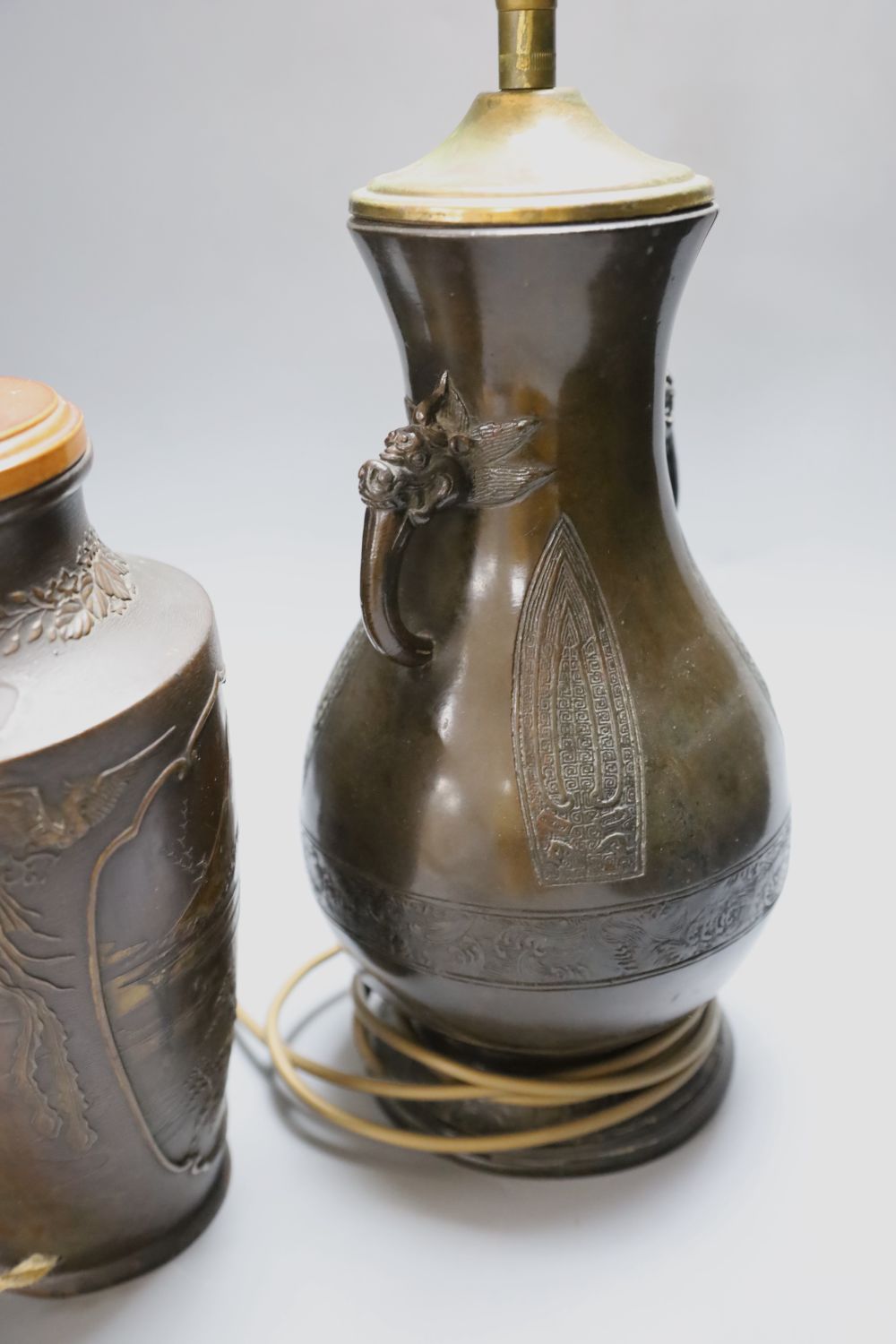 A Japanese bronze vase, late 19th century, later mounted as a lamp and a similar bronzed finished lamp